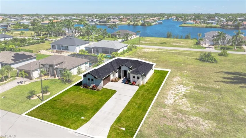 Aerial perspective of suburban area with a nearby body of water