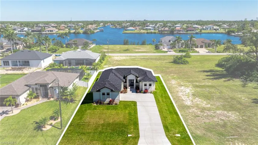 Aerial view of residential area featuring a large body of water