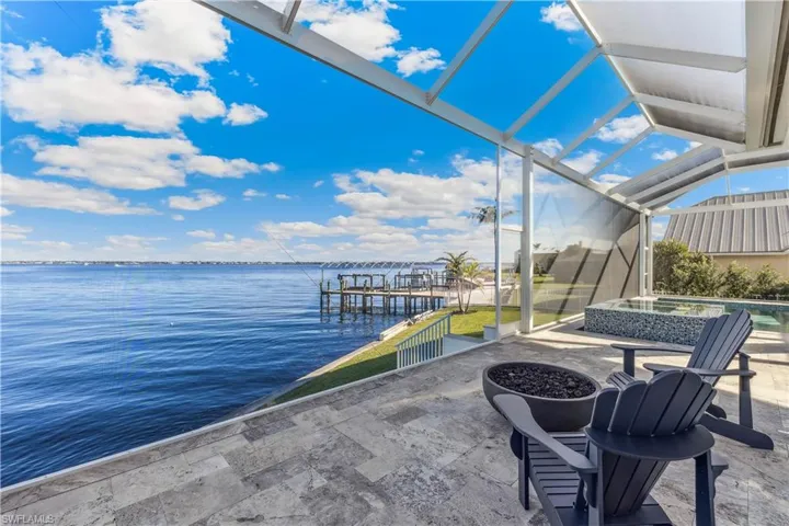 View of patio / terrace with a grill, sink, a water view, and exterior kitchen