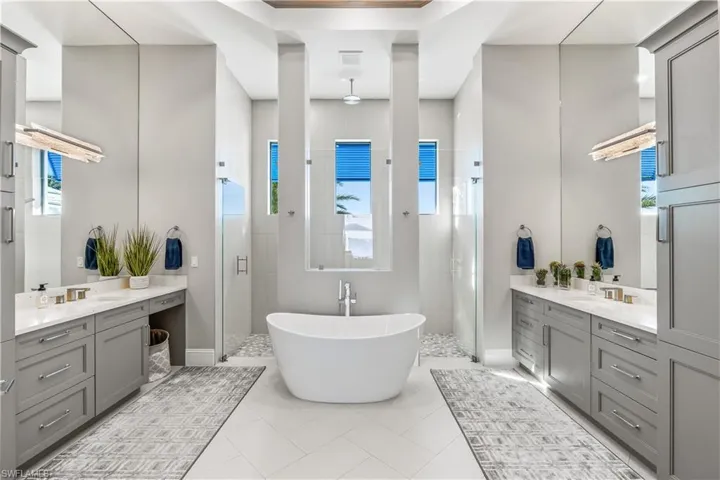 Bathroom with vanity, tile patterned flooring, and plus walk in shower