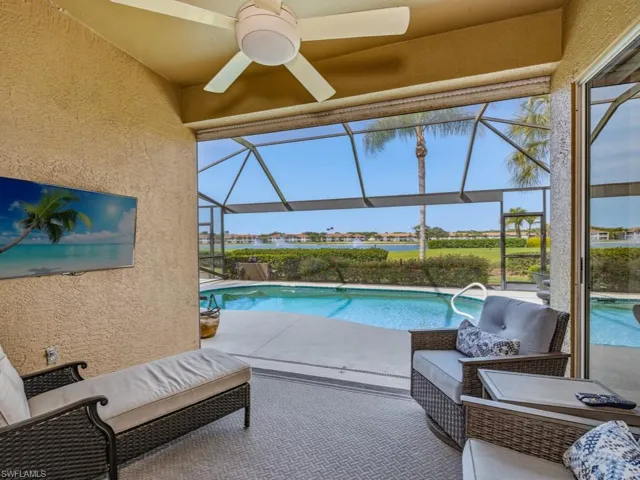 Outdoor pool featuring a sunroom, a patio, and a lanai