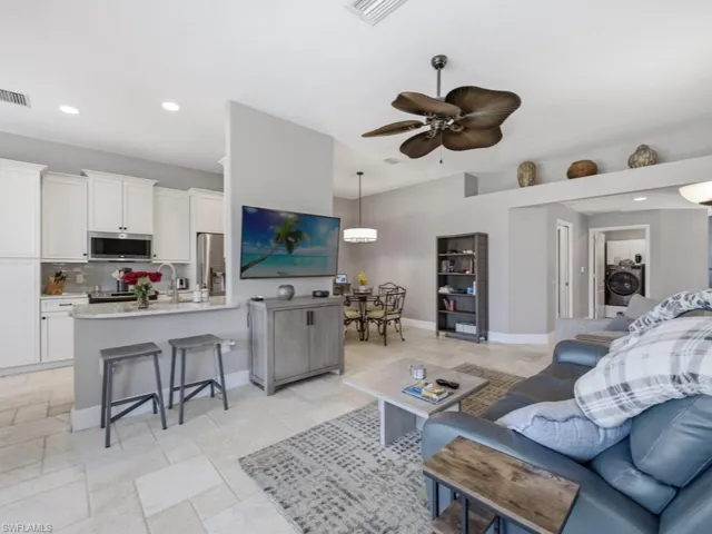 Living room featuring recessed lighting, ceiling fan, and washer / clothes dryer