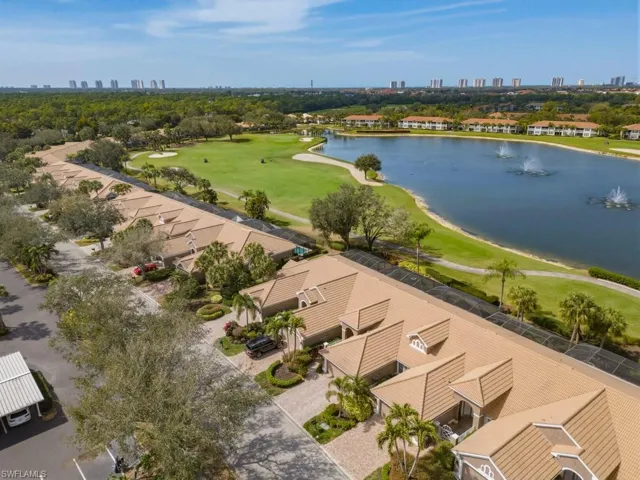 Drone / aerial view of city skyline, a golf club, and a large body of water