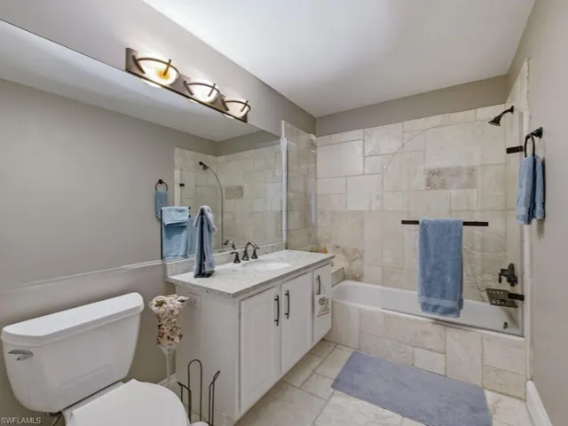 Full bathroom featuring tiled shower / bath and vanity