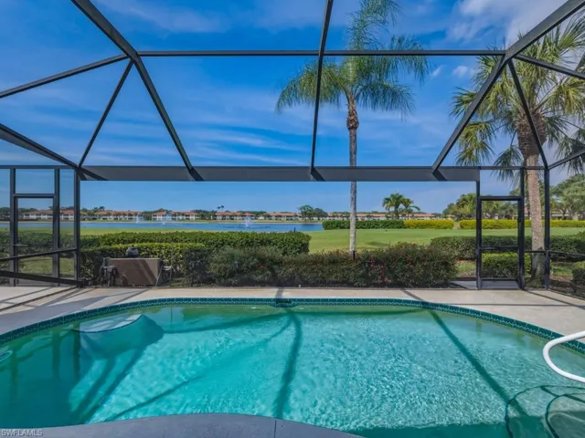 Outdoor pool with a sunroom and glass enclosure
