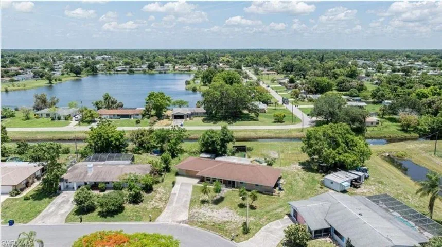 Birds eye view of property with a water view