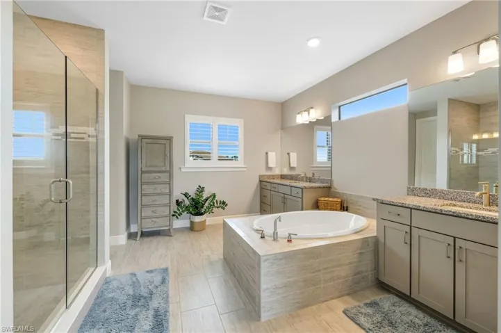 Bathroom with double vanity and separate shower and tub