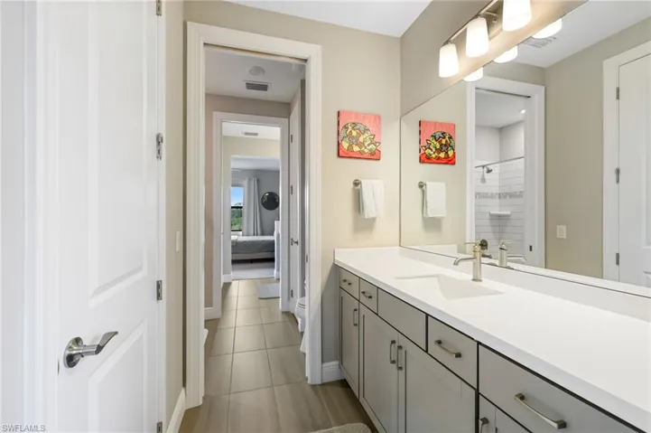Bathroom featuring tile patterned flooring and vanity