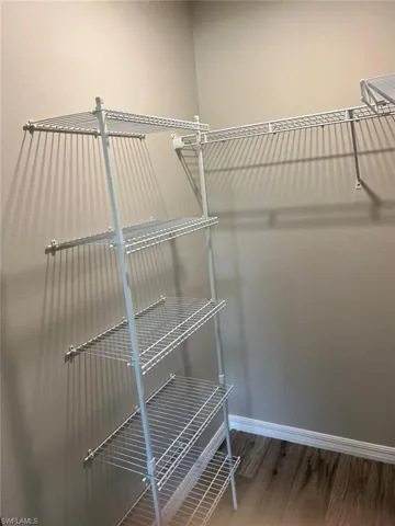 Spacious closet with light wood finished floors