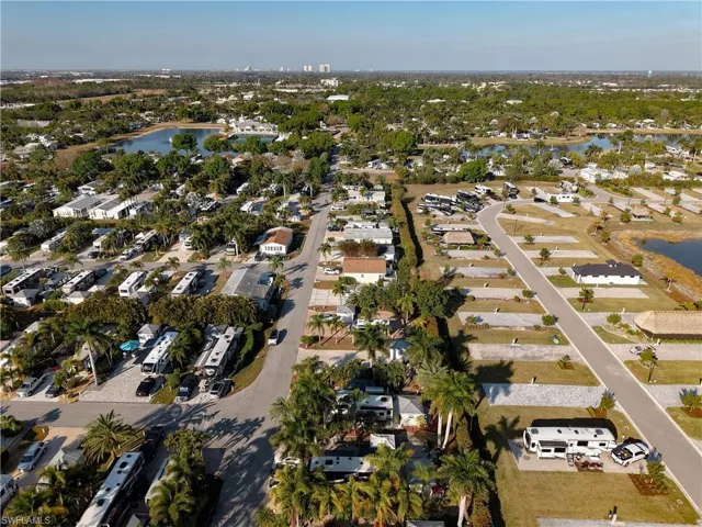 Aerial view of property's location with nearby suburban area and a nearby body of water