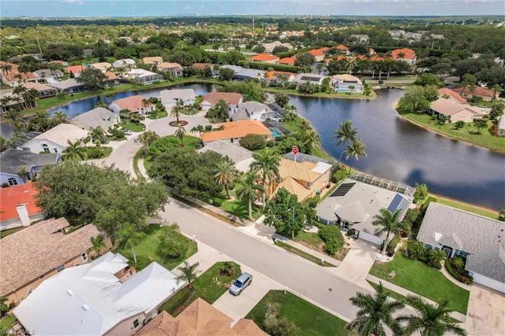 Aerial view of residential area featuring a large body of water