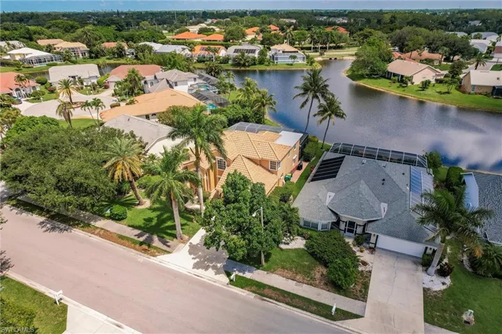 Aerial view of residential area featuring a nearby body of water