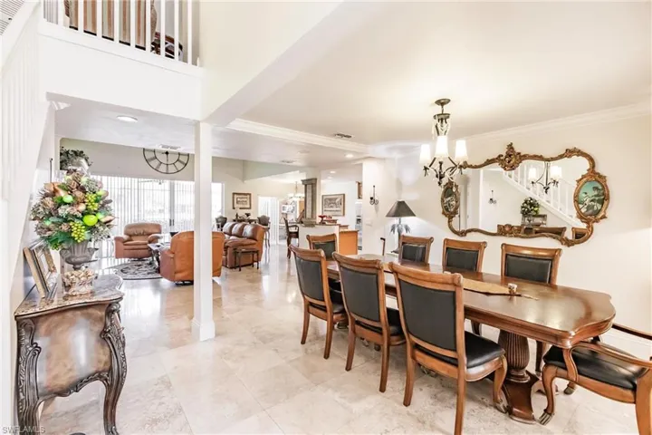 Dining room with a chandelier and crown molding