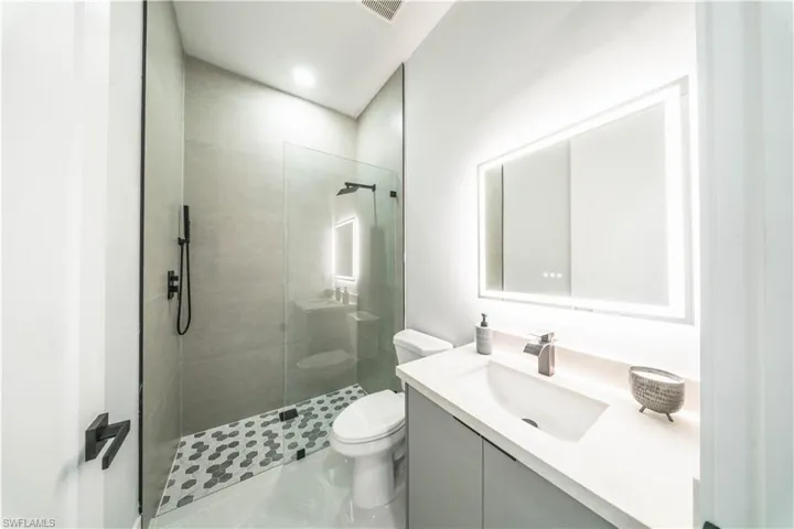 Full bath with vanity, walk in shower, and recessed lighting