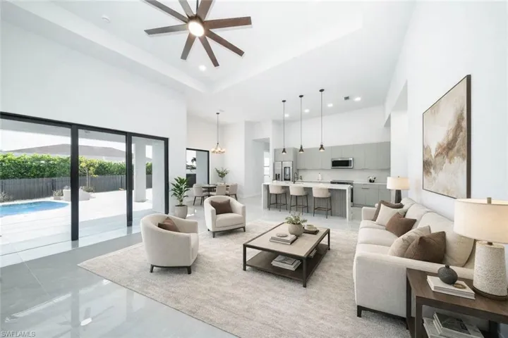 Kitchen with stainless steel appliances, modern cabinets, gray cabinets, an island with sink, and pendant lighting