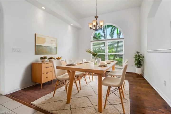 Dining area featuring wood-type flooring and a notable chandelier