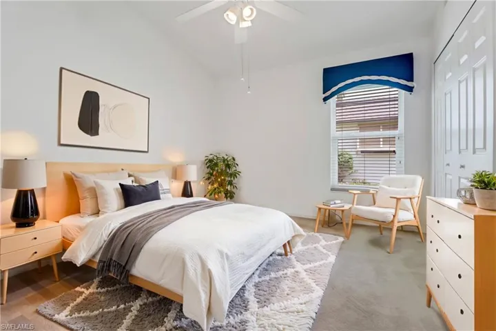 Bedroom featuring carpet, a closet, lofted ceiling, and ceiling fan