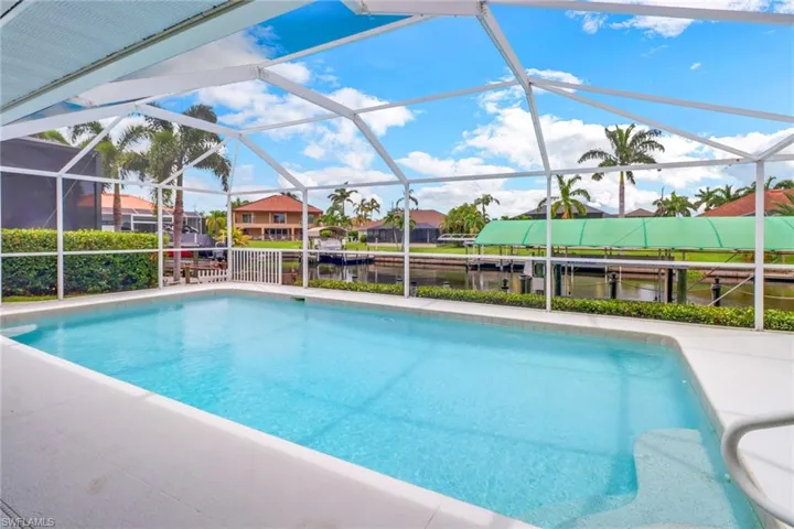View of swimming pool with glass enclosure