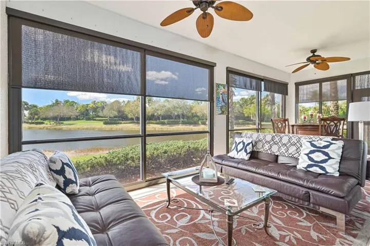 Expansive window wall overlooking a water feature and lush landscaping