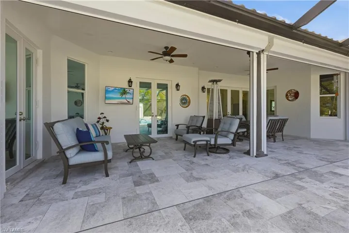 View of patio / terrace with french doors and ceiling fan