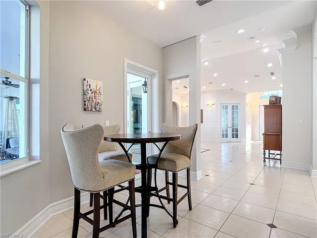 Dining room featuring light tile patterned flooring and recessed lighting