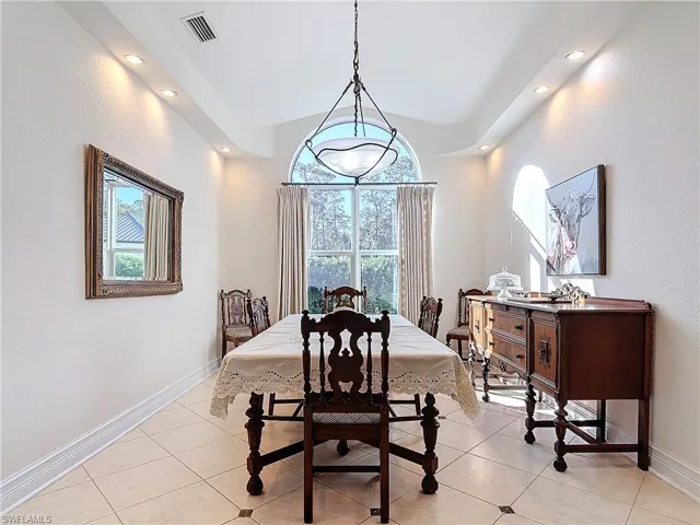 Dining room with a textured wall and light tile patterned floors