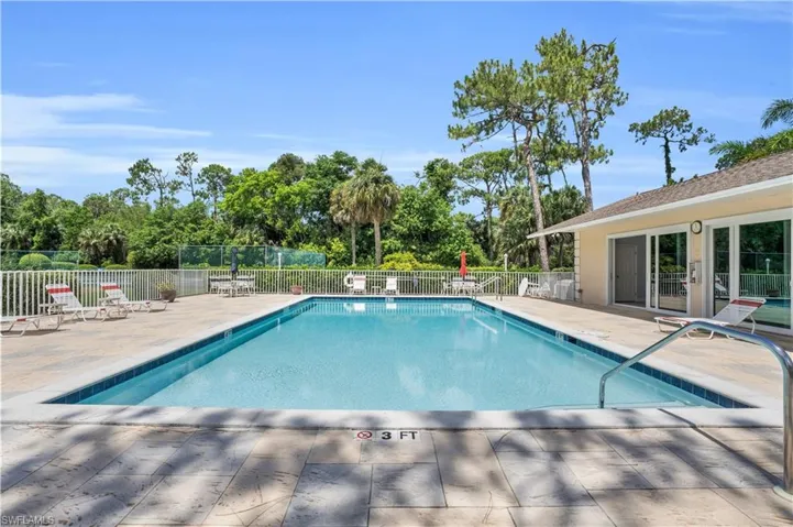View of community swimming pool featuring a patio area