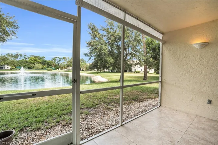 Patio with a water view with sunshade
