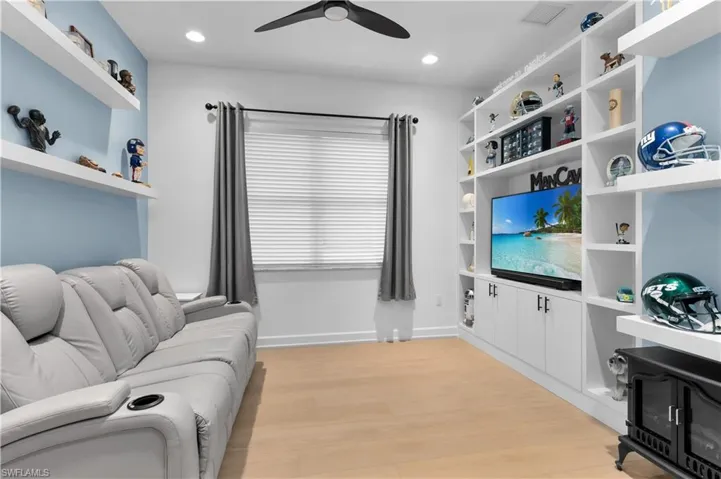 Den with light wood-style floors, a ceiling fan, and recessed lighting