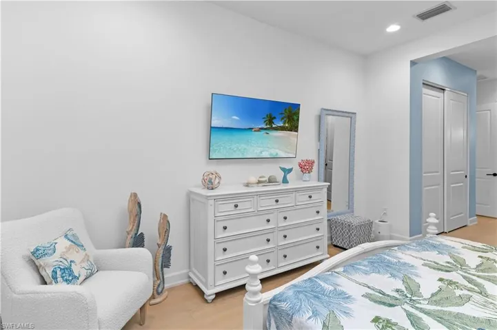 Bedroom with light wood-style floors and recessed lighting