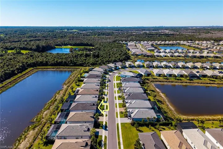 Aerial perspective of suburban area featuring a large body of water