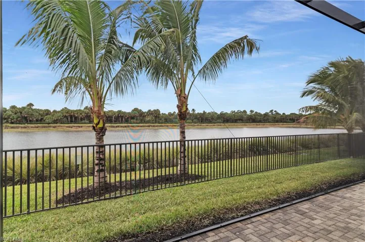 Water view featuring a fenced backyard and a tree filled landscape