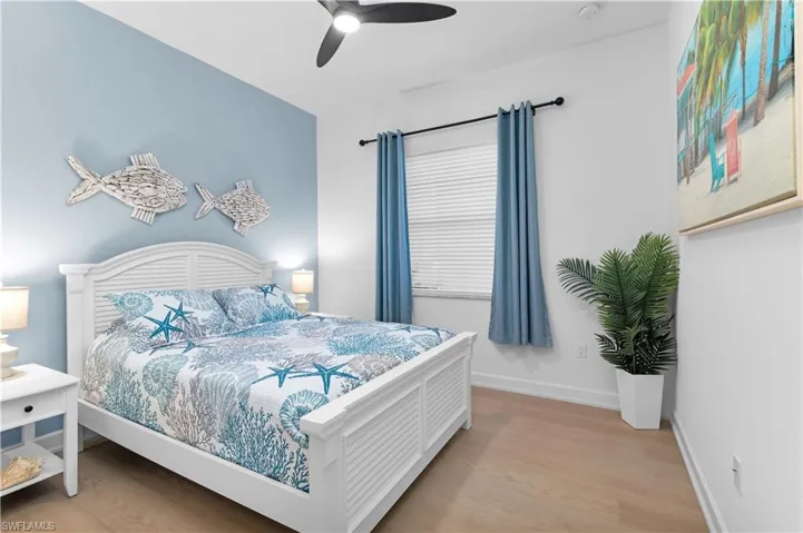 Bedroom with light wood-style floors and ceiling fan