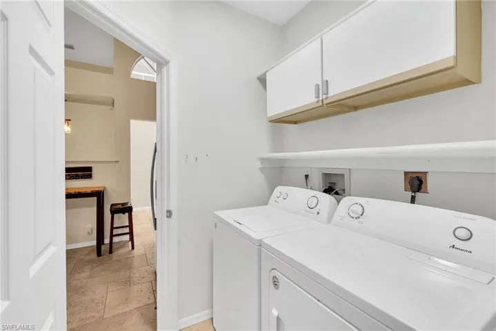 Dedicated laundry area featuring a white washing machine and dryer