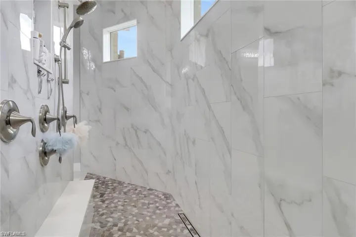 Full bath featuring tiled shower