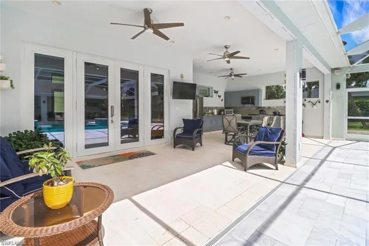 View of patio / terrace with french doors, a ceiling fan, and area for grilling