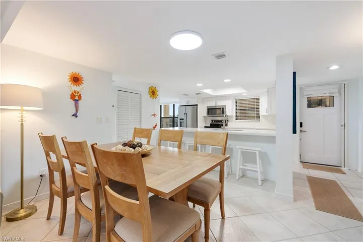 Dining room with light tile patterned floors and sink