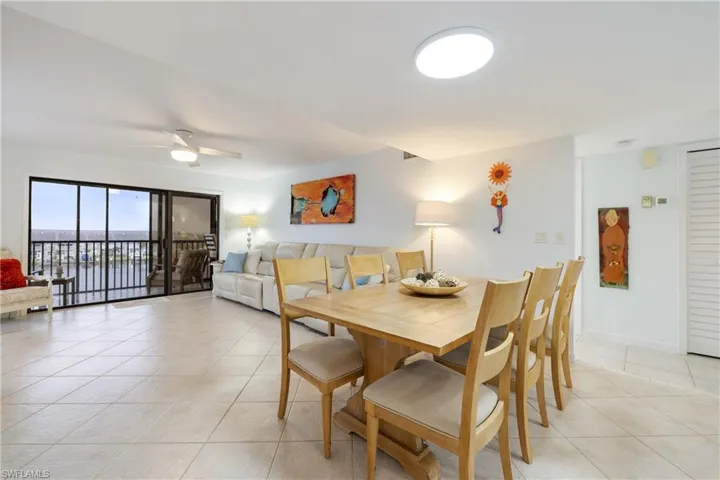 Tiled dining room featuring ceiling fan