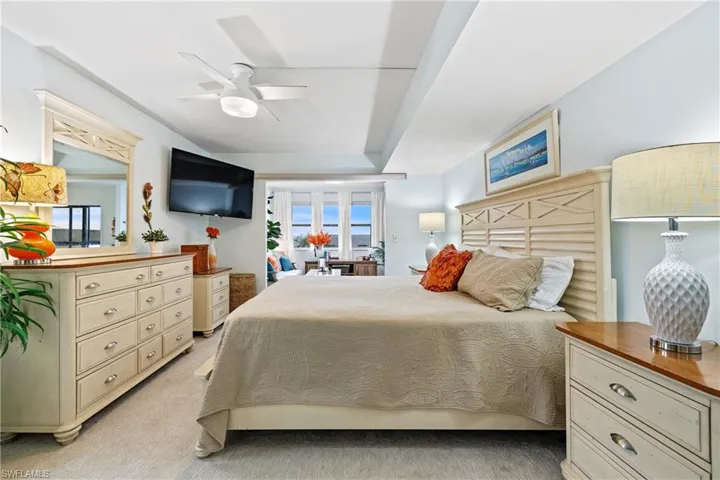 Carpeted bedroom with ceiling fan