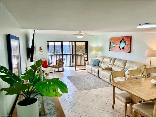 Tiled living room featuring ceiling fan