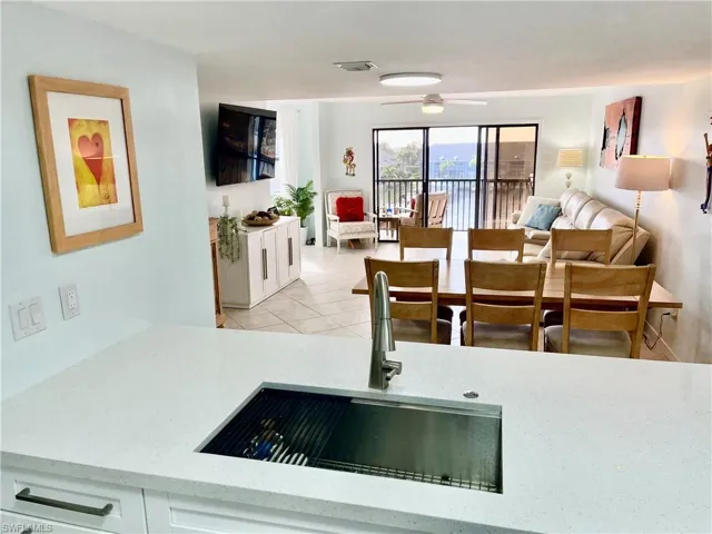 Tiled dining area featuring sink and ceiling fan
