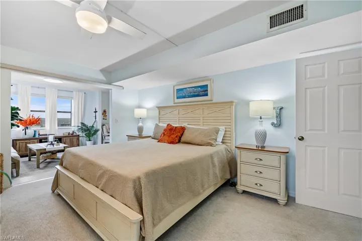 Carpeted bedroom with ceiling fan