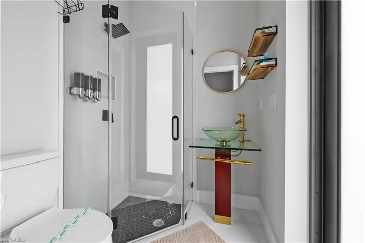 Full bathroom featuring a shower stall and tile patterned floors