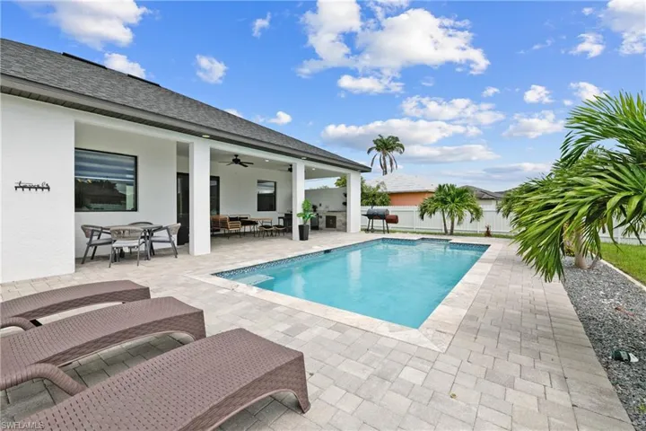 View of pool with a patio, ceiling fan, outdoor lounge area, and outdoor dining space