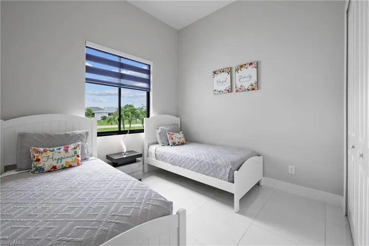Bedroom with light tile patterned floors and a closet