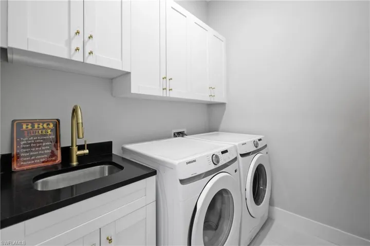Laundry room featuring washing machine and dryer and cabinet space