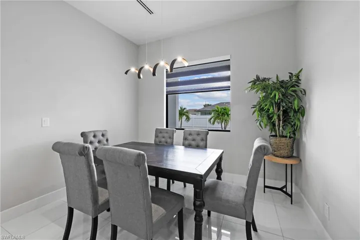 Dining room with light tile patterned floors and baseboards