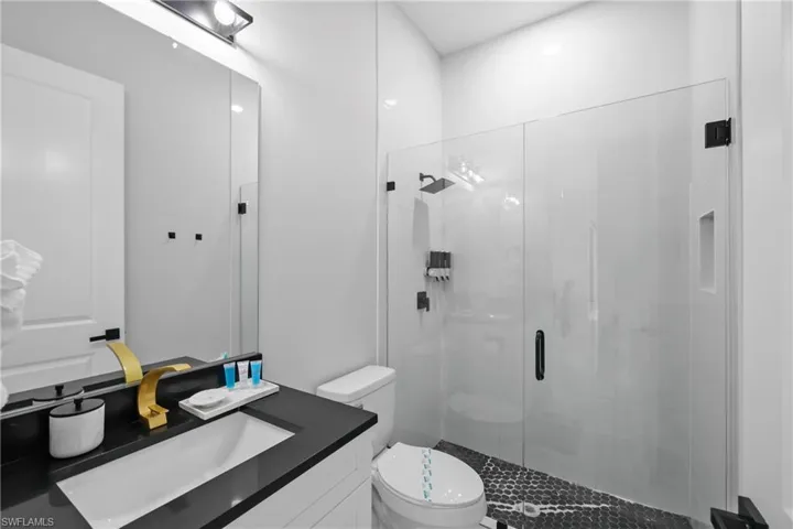 Full bath with a stall shower and vanity