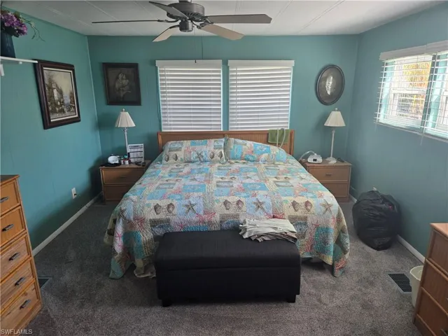 Carpeted bedroom with ceiling fan