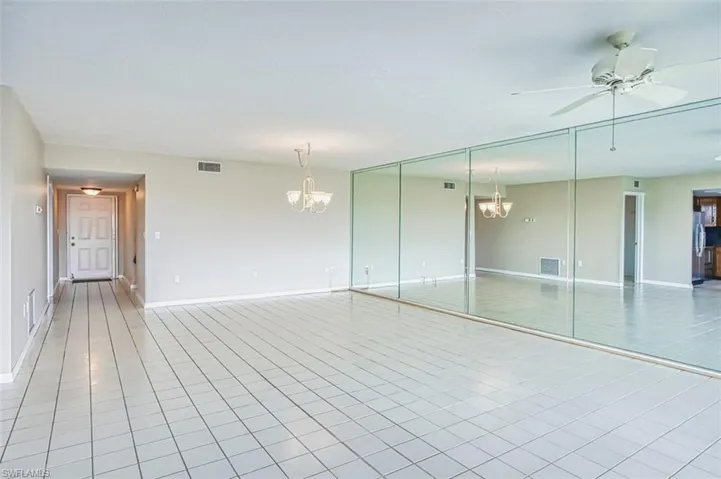 Living Room with a chandelier, ceiling fan, and light tile patterned flooring